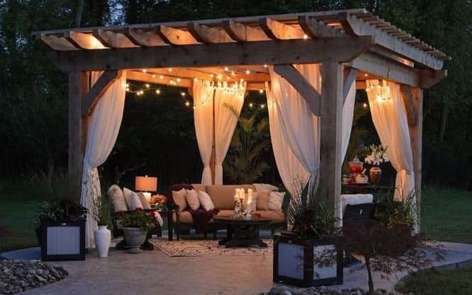 photo of gazebo with curtain and string lights